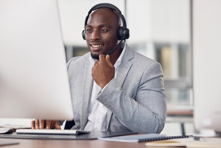 A professional African interviewer conducting a telephone survey in Africa using CATI technology, capturing voice-based consumer insight with warmth and credibility