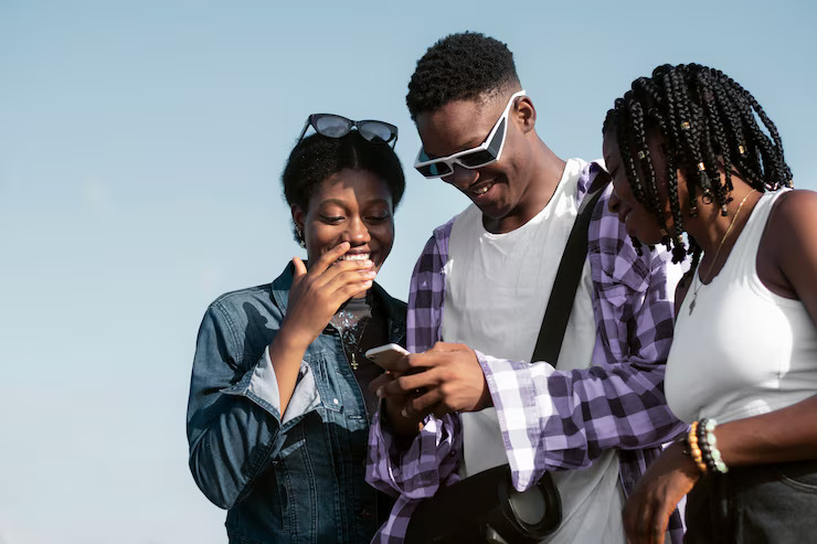Persons in Ghana checking a telephone survey call on a mobile phone