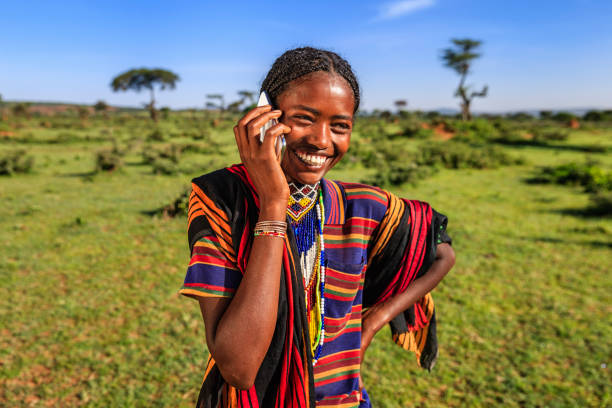 A woman in a rural responding to a mobile telephone survey in the farm