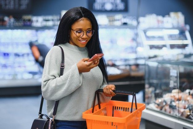 African consumer in a shopping mall sharing honest feedback during a telephone survey