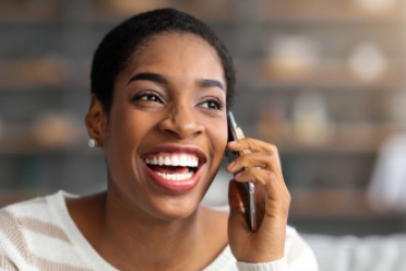 A thoughtful African respondent speaking on the phone during a telephone survey, reflecting the emotional depth and honesty in voice-based research.