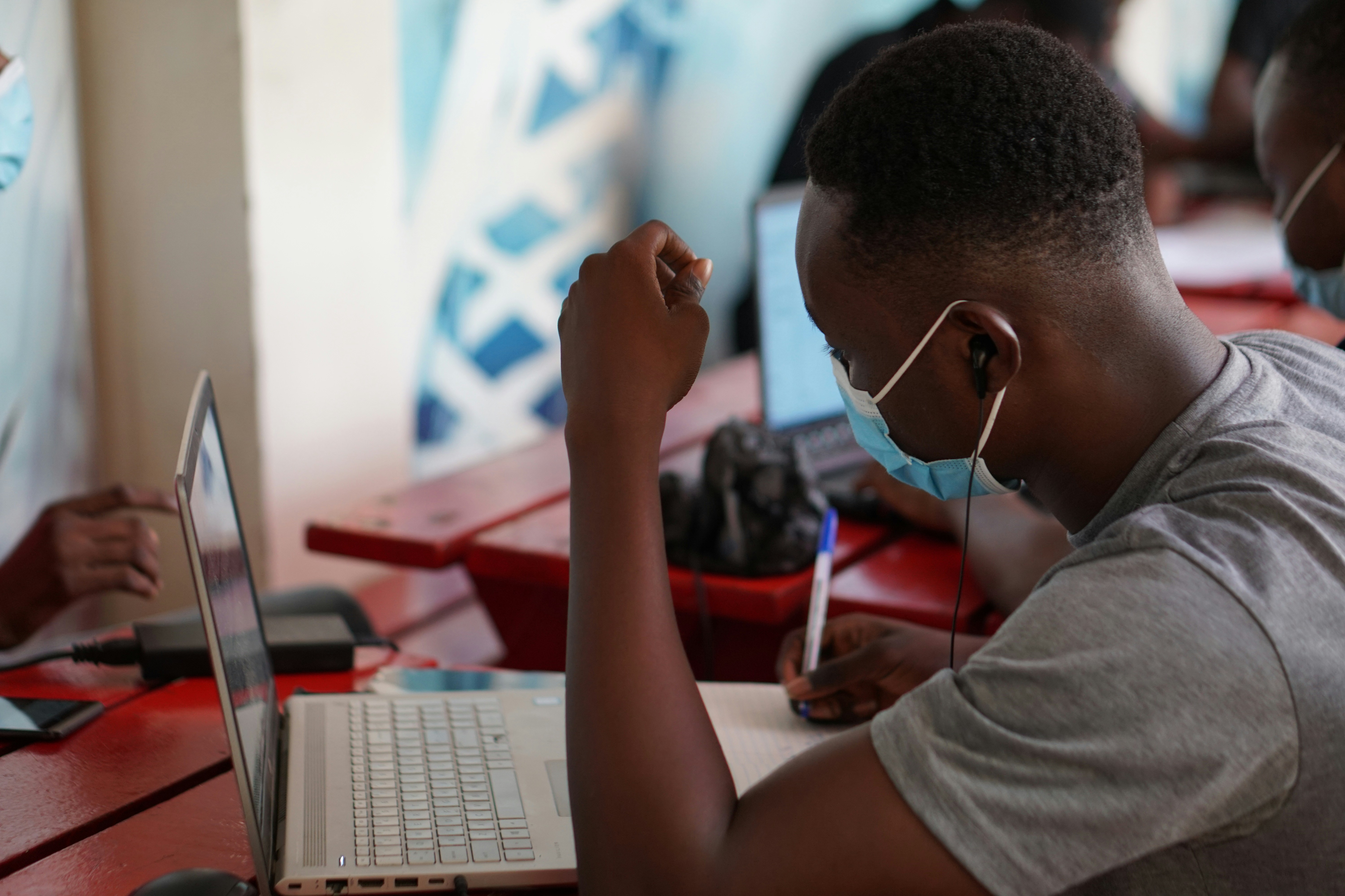 CATI interviewer collecting survey data through a phone call using digital software for health, education, and governance research in Africa.