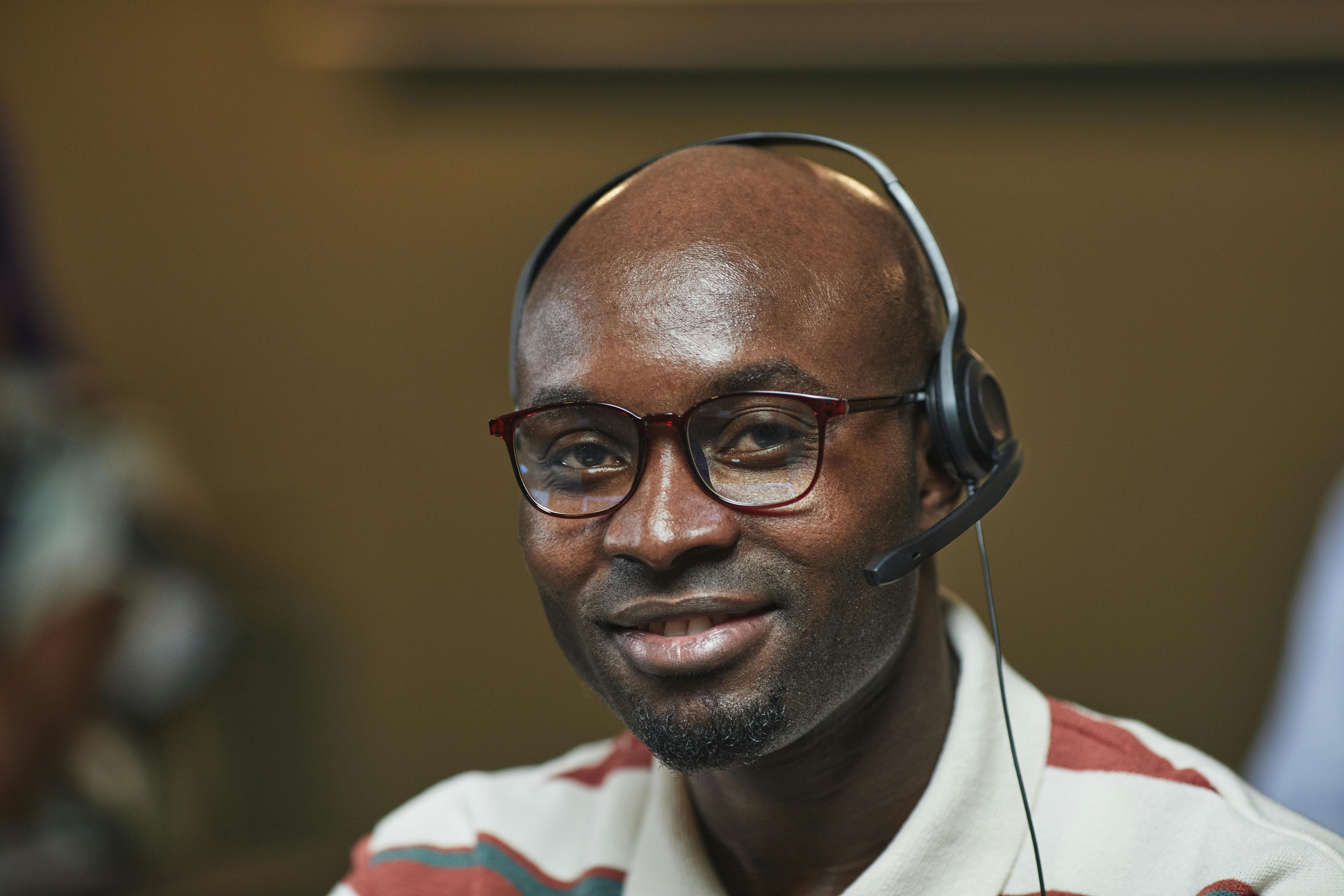 Respondent in rural Africa participating in a telephone survey using a basic mobile phone, enabling inclusive research.