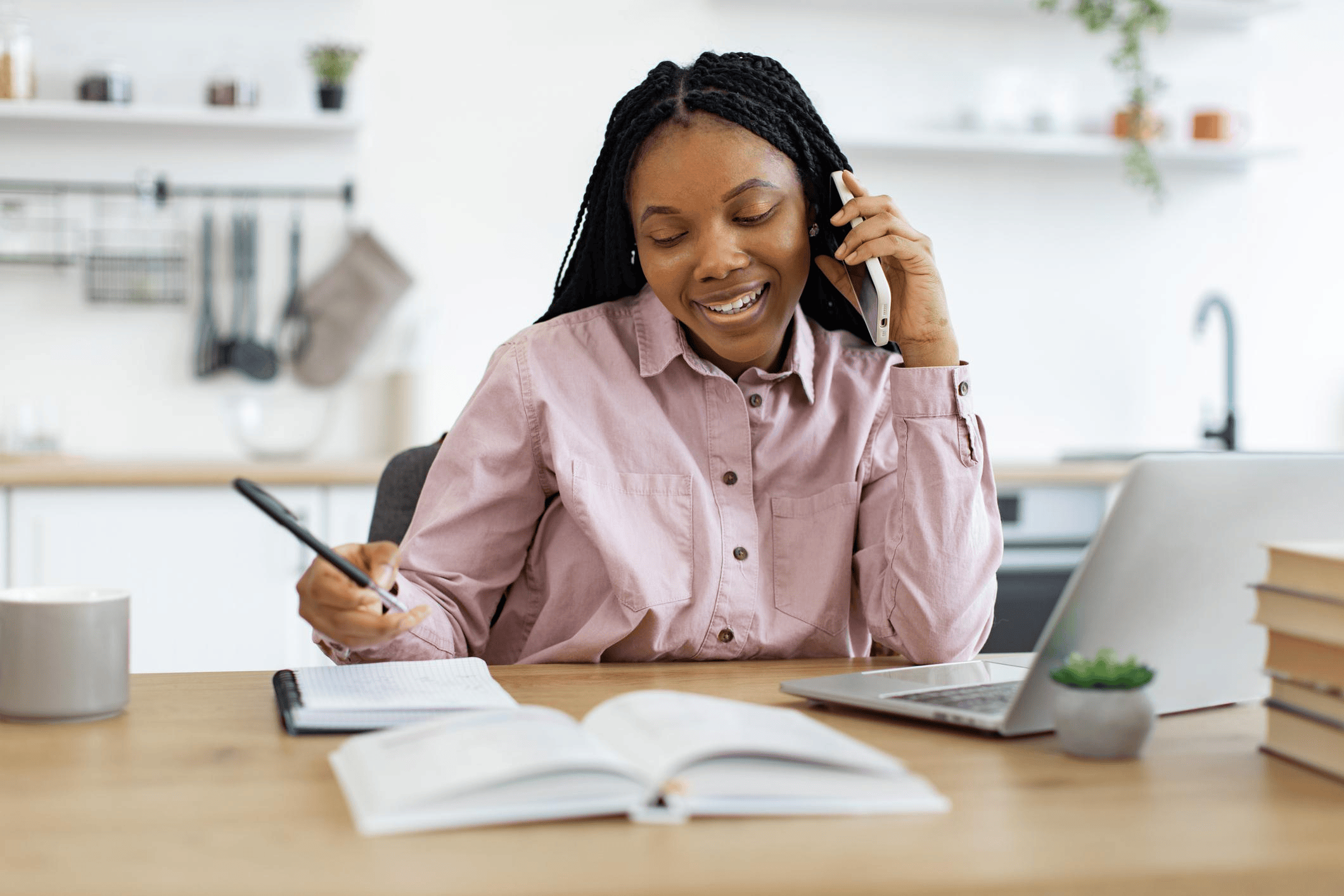 African researcher conducting a telephone survey with a respondent
